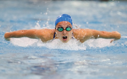 Photo of Megan Burns in the pool during a swimming competition. 