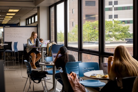 Students use laptops in Capen Hall. 