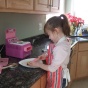 young girl makes a cake. 