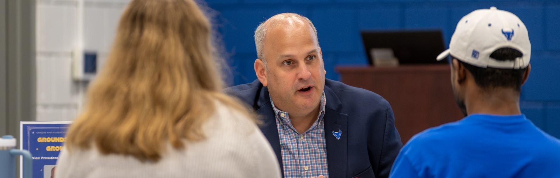 VPSL Brian Hamluk meeting with students at a conference room table. 