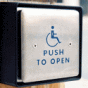 Electronic door opener with accessibility symbol. 