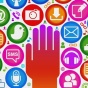 A hand, surrounded by symbols for email, a microphone, twitter and other multimedia-related symbols. 