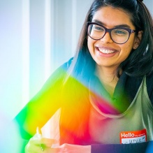 Student smiling in a classroom. 