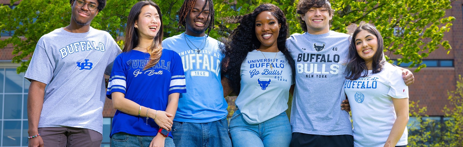 Group of UB students in UB shirts smiling. 