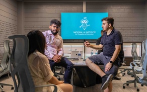 Students at a conference table. 