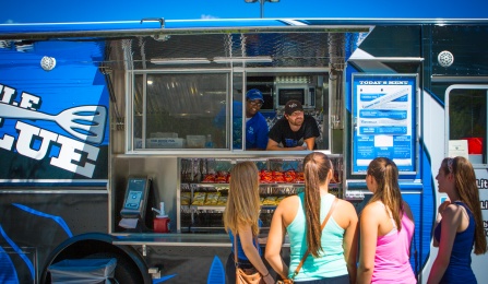 Students working in a food truck on campus. 