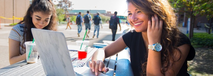 Student working at a picnic table. 