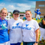 Three women wearing University at Buffalo Gear, during a summer event on Campus. 