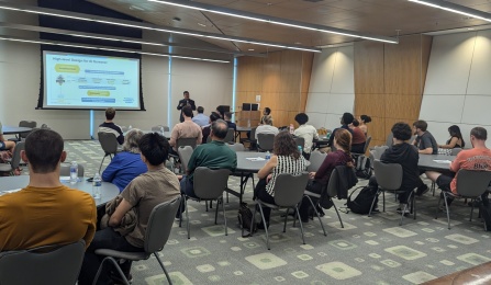 Jinjun Xiong delivers a presentation to an audience. 