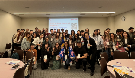 A group poses at a Conference. 