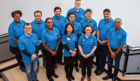 AI Institute leadership standing together wearing matching blue shirts. 