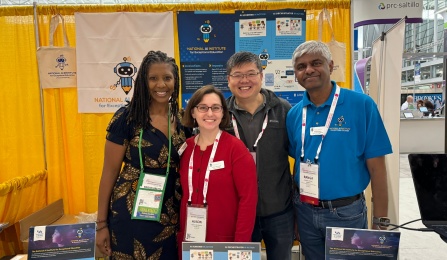 AI Institute faculty standing at their information booth at the ASHA convention. 