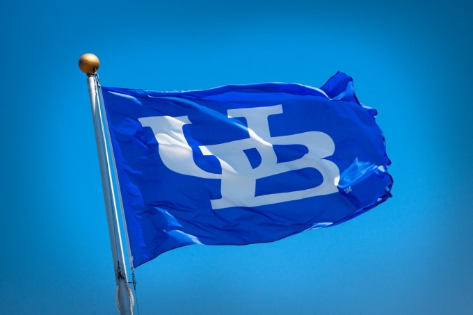 The UB flag flies high in the sky. 