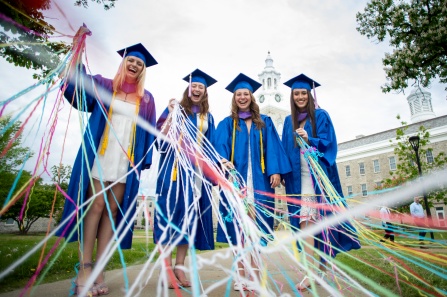 Graduates and their guests take photos near the Hayes Hall on South Campus in May 2024. 
