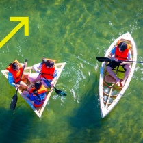 Zoom image: UB students in kyaks on Bond lake from above 