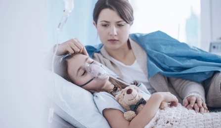 A health care provider cares for a young cyctic fibrosis patient. 