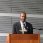 Still image of a video by Rodney McMillian casting himself as politician. 