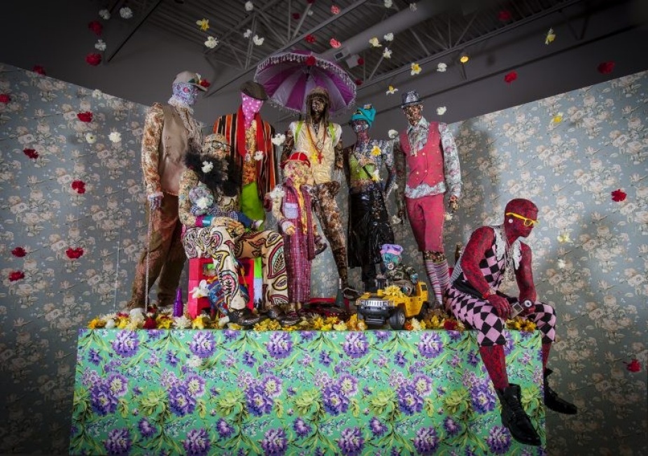 Photography of installation with various patterned clothing on mannequins. 