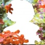 Still Image from Video by Andrea Chung of bobbed hair figure in white surrounded by botanical objects. 