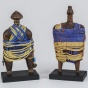 Collage on selected African sculpture tied with blue and yellow beads straps forming like a clothing of each sculpture. 