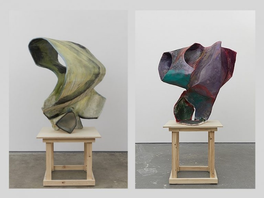 Sculptures by Ernesto Burgos of two different abstract forms on the wooden stool. One on the left being in shades of green and right with range of purple with turquoise. 