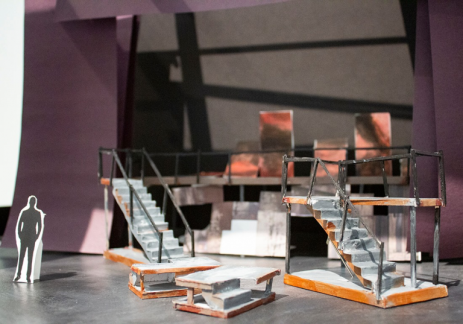 a photo of a small model of a set for Three Penny Opera with modular stairs and a small scale model person. 