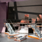 a photo of a small model of a set for Three Penny Opera with modular stairs and a small scale model person. 