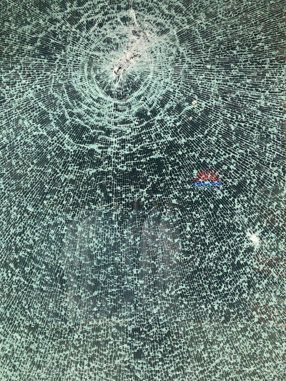 A photograph of tempered glass which has chattered but is still holding together. 