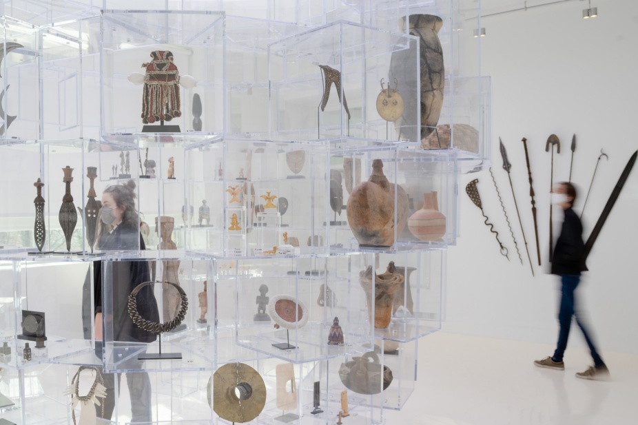 Photograph of two figures inside the Cravens Collection open storage system. 