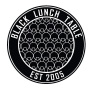 a logo for Black Lunch Table, a black circle with text that reads "Black Lunch Table, Est. 2005.". 