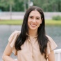 Portrait of Alexandra J. Gold, PhD. She stands outdoors near a railing, smiling at the camera. Photo: Christine Magee Photography. 