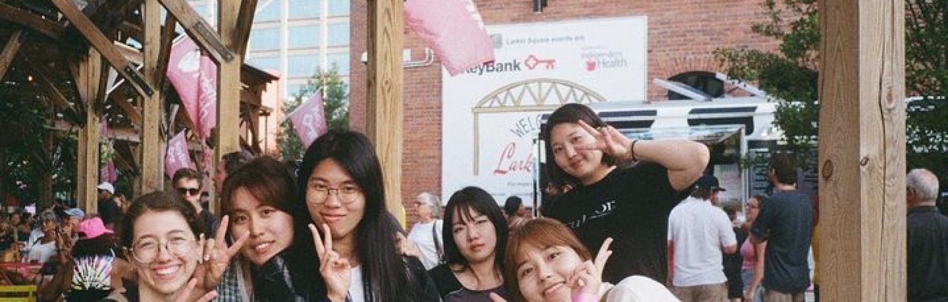 Group of Korean students at outdoor event at Larkin building. 
