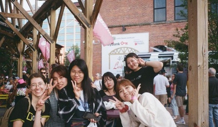 Group of Korean students at outdoor event at Larkin building. 