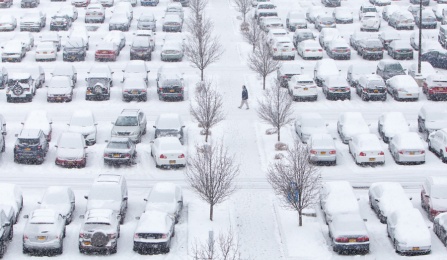 Snow covered Greiner Hall parking lot in December. 