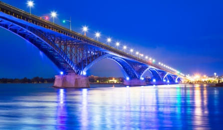 Image of the Peace Bride illuminated with blue lights. 