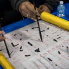 Students learning calligraphy at The World Bazaar in 2019. 