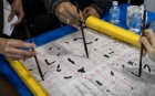 Students learning calligraphy at The World Bazaar in 2019. 