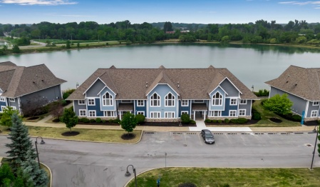 Exterior shot of South Lake Village Apartments with the lake in the background. 