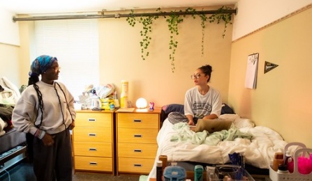 Students talking in dorm room of Governors Residence Halls on the North Campus. 