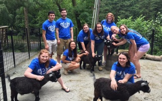 NRHH members at a petting zoo with goats for an event. 