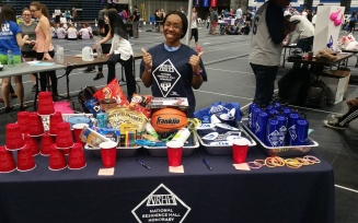 NRHH member tabling at an event with giveaways and snacks. 
