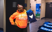 Zoom image: Two female students showing off their stuffed geese plushies..
