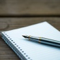 Image of pen on notebook. 