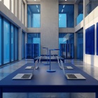 AI generated photo of a large room with laptops on a table. 