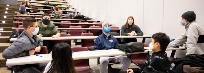 Prof. Jim Lemoine teaches the class Organizational Behavior in a NSC lecture hall on the first day of the spring semester in February 2021. The students worked in groups to build and fly paper airplanes at the start of classes. 
