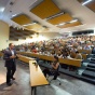 Image of guest speaker in front of lecture hall. 