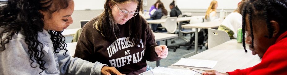 Students working around a table. 