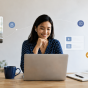 A group of higher education professionals participate in a virtual meeting from separate workspaces, connected through video call windows and subtle digital interface elements. 