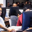 Top Hat students in classroom working on computers. 