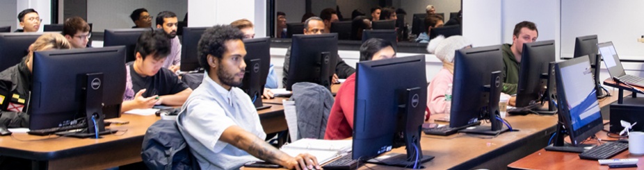 Top Hat students in classroom working on computers. 